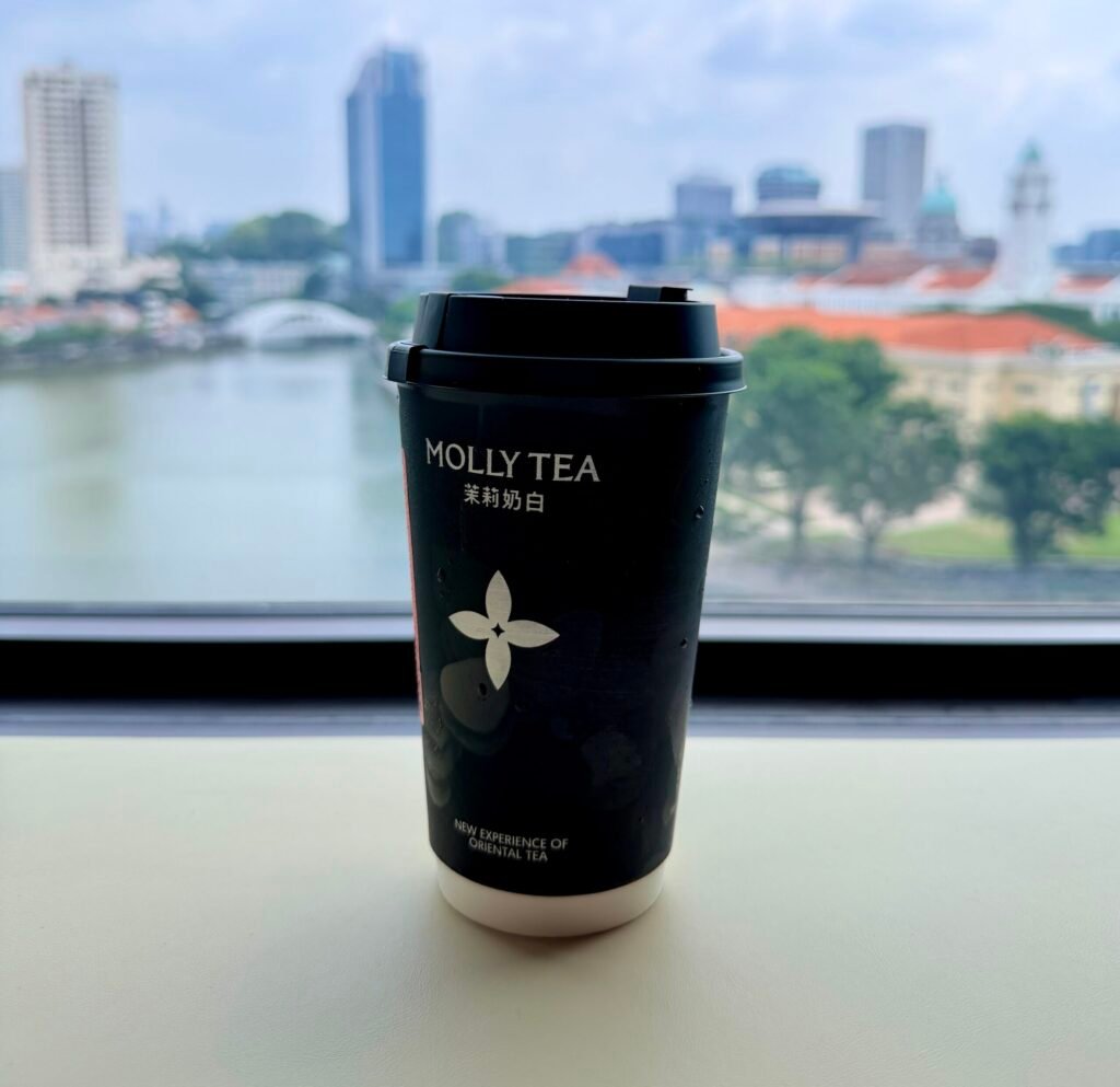 The most contested flower in luxury, with a view. Molly Tea’s four-petal emblem — now the subject of a S$1.96 million trademark ruling — overlooking the Singapore River.